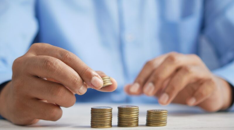 a person stacking coins on top of a table