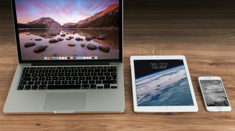 Macbook Pro Beside White Ipad